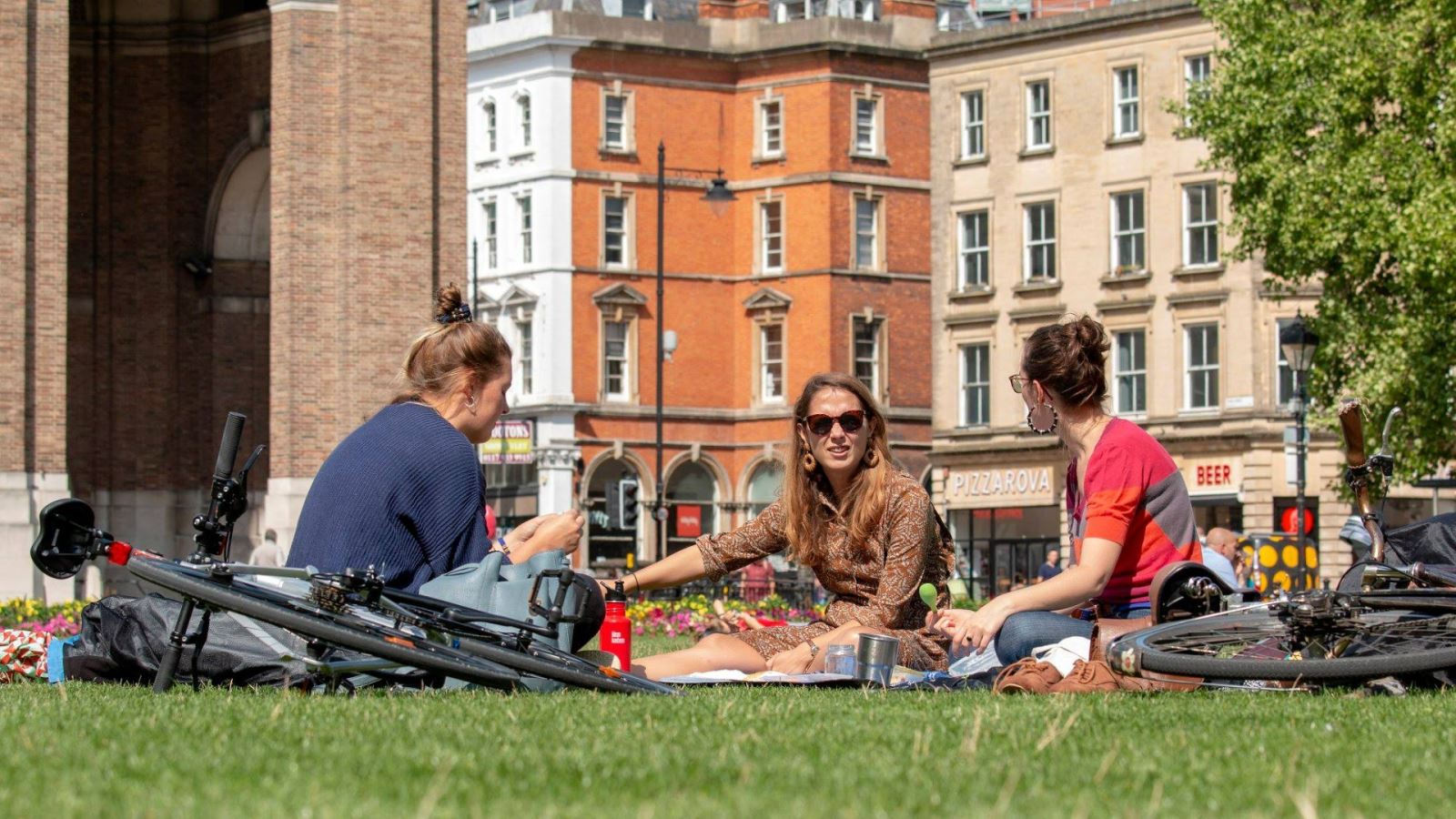 Group of women have a picnic on College Green